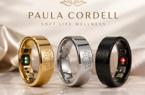 
Paula Cordell Smart Wellness Rings in gold, silver, and black on a soft satin background